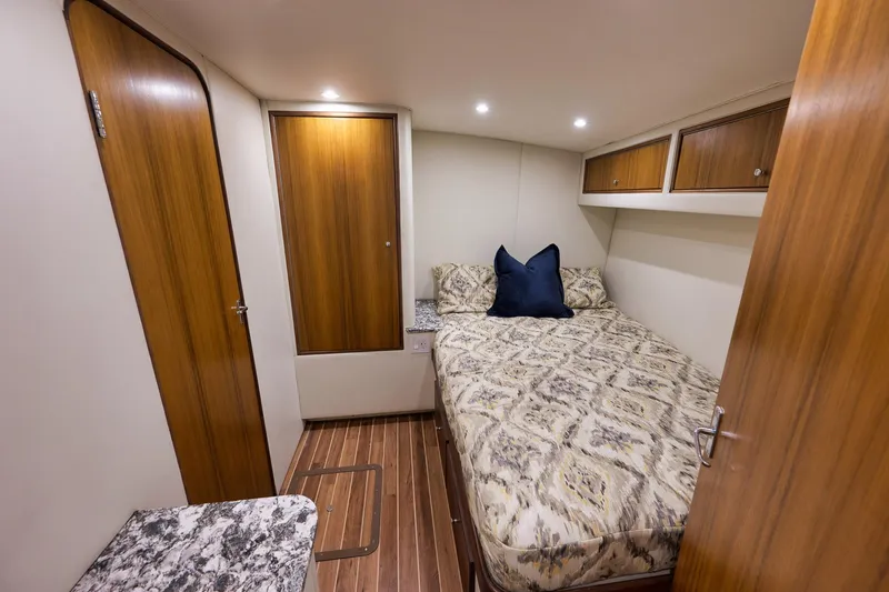 Slide: The Image of Cozy cabin interior of 2004 Guthrie 60 Custom Carolina yacht with wood accents and patterned bedding. - 34