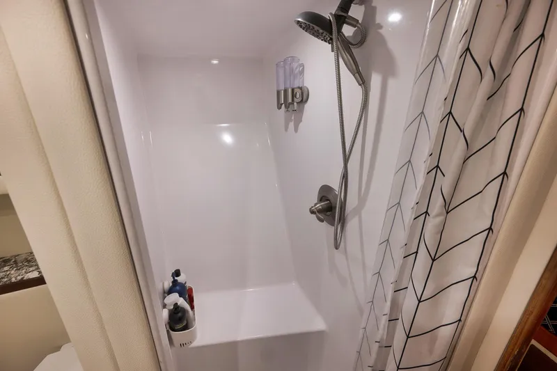 Slide: The Image of Shower area in 2004 Guthrie 60 Custom Carolina boat with modern fixtures and curtain. - 38