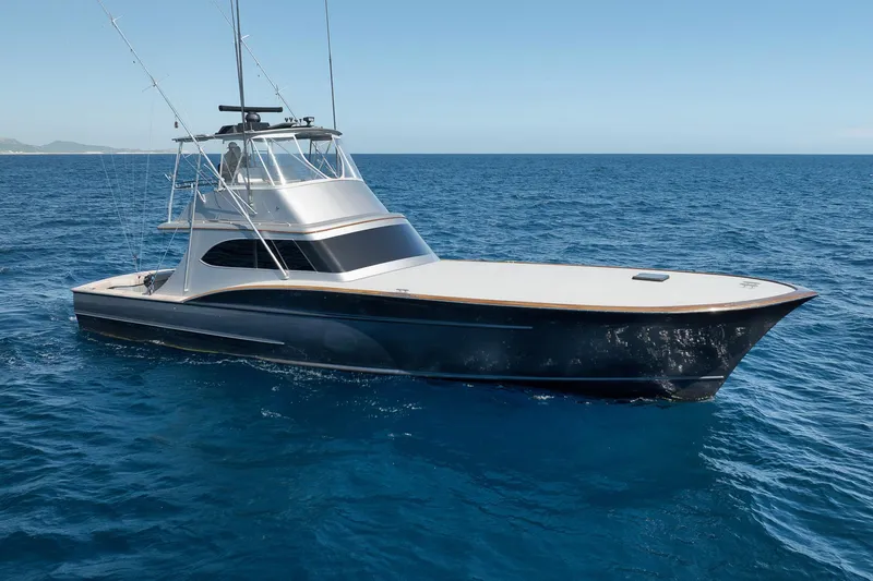 Slide: The Image of 2004 Guthrie 60 Custom Carolina yacht on open sea, clear blue sky. - 43