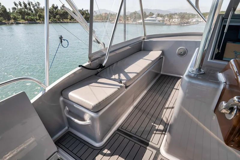 Slide: The Image of 2004 Guthrie 60 Custom Carolina boat deck with cushioned seating and scenic water view. - 47