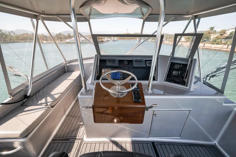 Slide: The Image of 2004 Guthrie 60 Custom Carolina yacht helm with steering wheel and navigation equipment. - 48