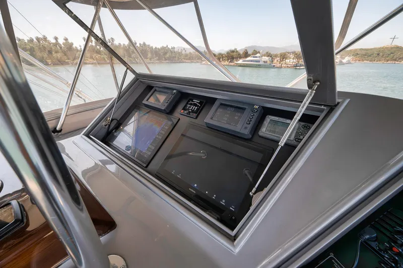 Slide: The Image of Control panel of 2004 Guthrie 60 Custom Carolina yacht, featuring navigation and monitoring systems. - 49