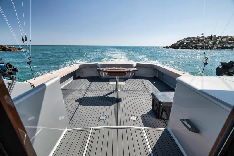 Slide: The Image of 2004 Guthrie 60 Custom Carolina boat deck with ocean view and fishing rods. - 58