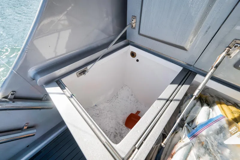 Slide: The Image of Open storage compartment on 2004 Guthrie 60 Custom Carolina boat with ice and fish. - 60