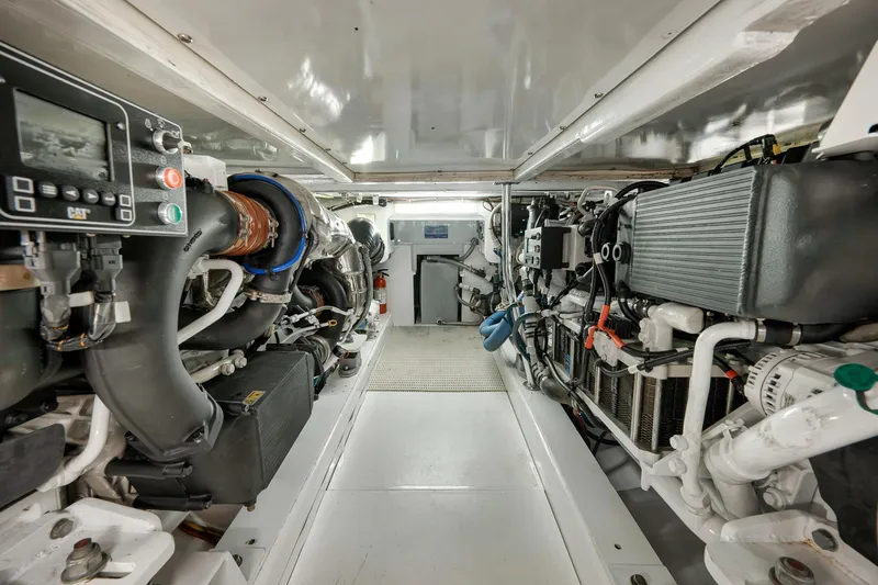 Slide: The Image of Engine room of 2004 Guthrie 60 Custom Carolina boat, showcasing detailed machinery and components. - 65
