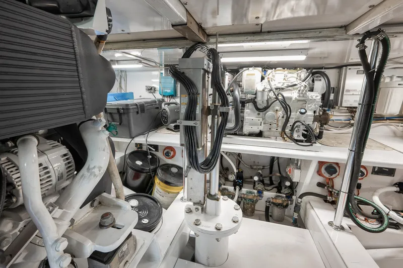 Slide: The Image of Engine room of 2004 Guthrie 60 Custom Carolina boat, showcasing mechanical components and wiring. - 69