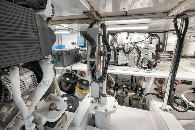 Slide: The Image of Engine room of 2004 Guthrie 60 Custom Carolina boat, showcasing mechanical components and wiring. - 70