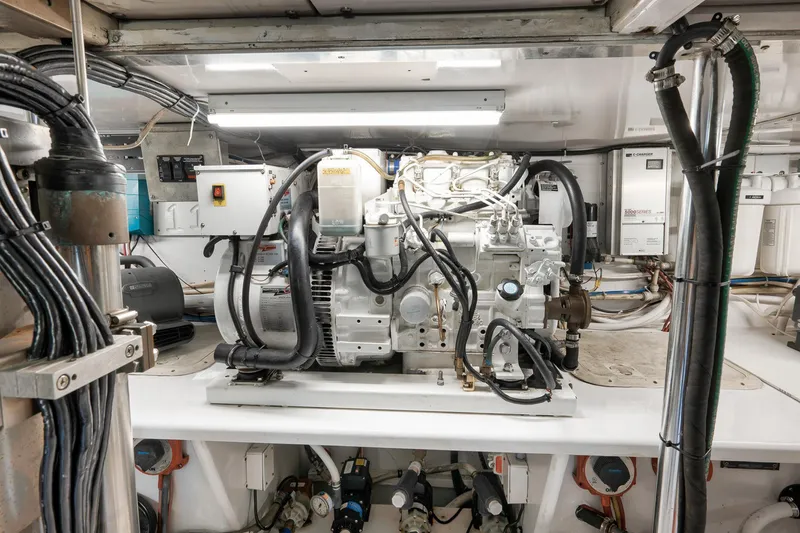 Slide: The Image of Engine room of 2004 Guthrie 60 Custom Carolina boat, featuring complex machinery and wiring. - 71