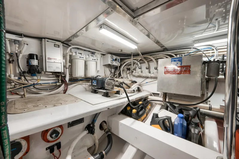 Slide: The Image of Engine room of 2004 Guthrie 60 Custom Carolina boat with equipment and storage. - 72