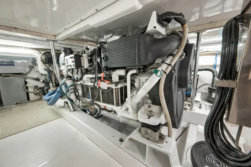 Slide: The Image of Engine room of 2004 Guthrie 60 Custom Carolina boat, showcasing detailed machinery and components. - 74