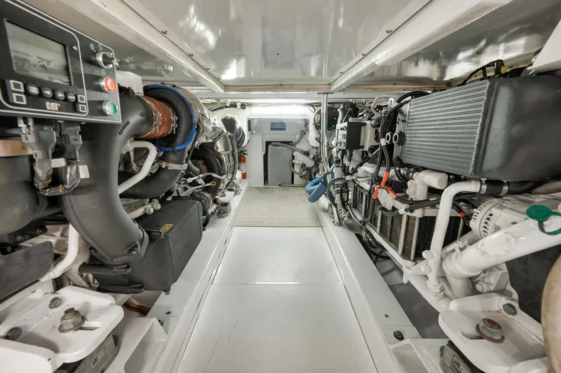 Slide: The Image of Engine room of 2004 Guthrie 60 Custom Carolina boat, showcasing detailed machinery and components. - 76