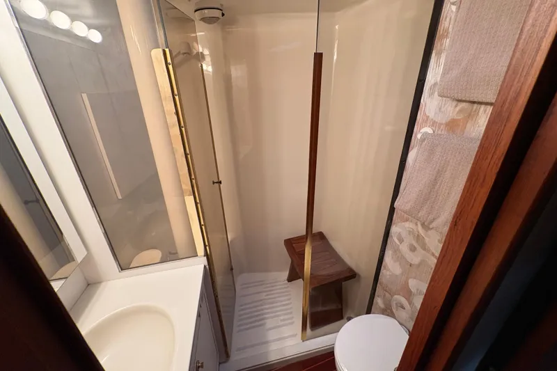Slide: The Image of Bathroom interior of 1996 Ocean Yachts 48 Super Sport with shower and wooden accents. - 25