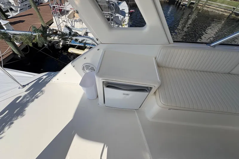Slide: The Image of 1996 Ocean Yachts 48 Super Sport deck with seating and mini fridge. - 10
