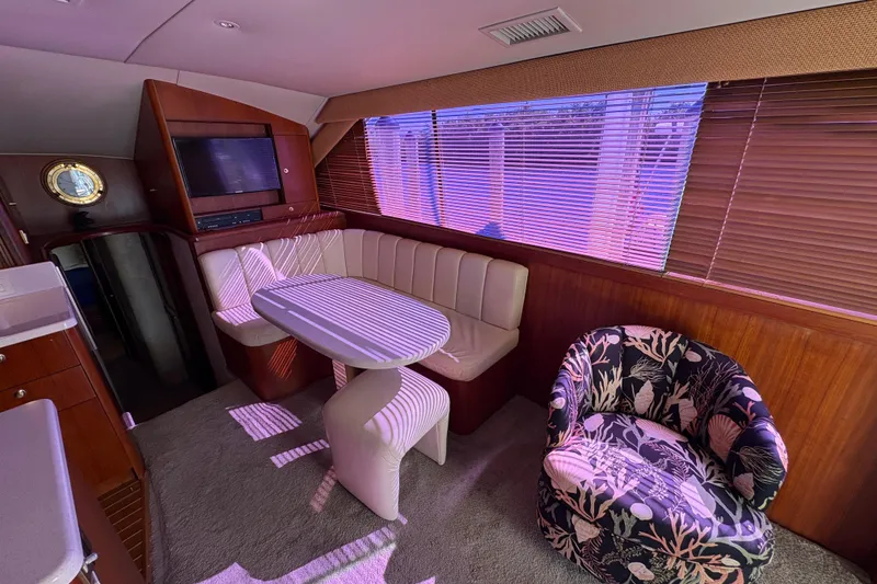 Slide: The Image of Interior of 1996 Ocean Yachts 48 Super Sport with dining area and floral chair. - 12