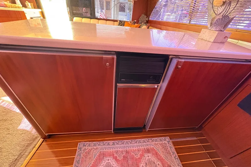 Slide: The Image of Interior of 1996 Ocean Yachts 48 Super Sport with wooden cabinetry and countertop. - 15