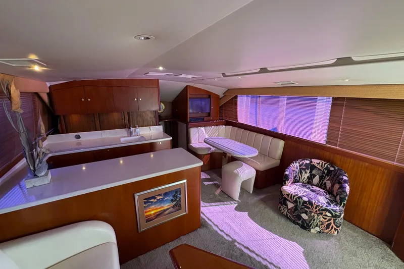 Slide: The Image of Luxurious interior of a 1996 Ocean Yachts 48 Super Sport with elegant seating and wood finishes. - 17