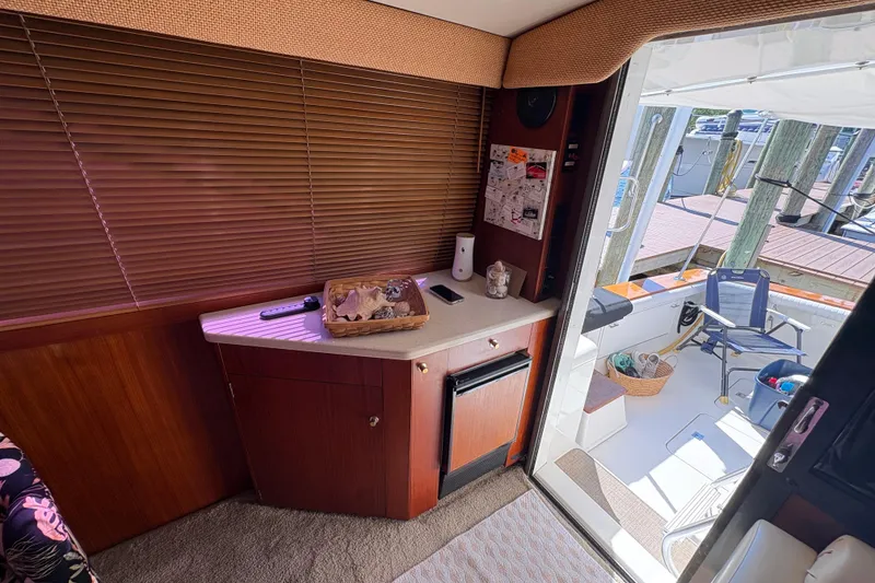 Slide: The Image of Interior of 1996 Ocean Yachts 48 Super Sport with deck view and cozy seating area. - 18