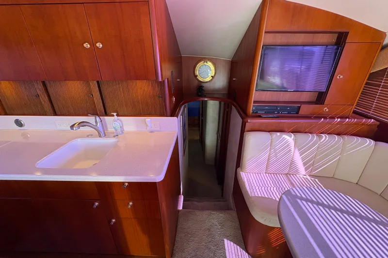 Slide: The Image of Luxurious interior of 1996 Ocean Yachts 48 Super Sport with kitchen and seating area. - 20