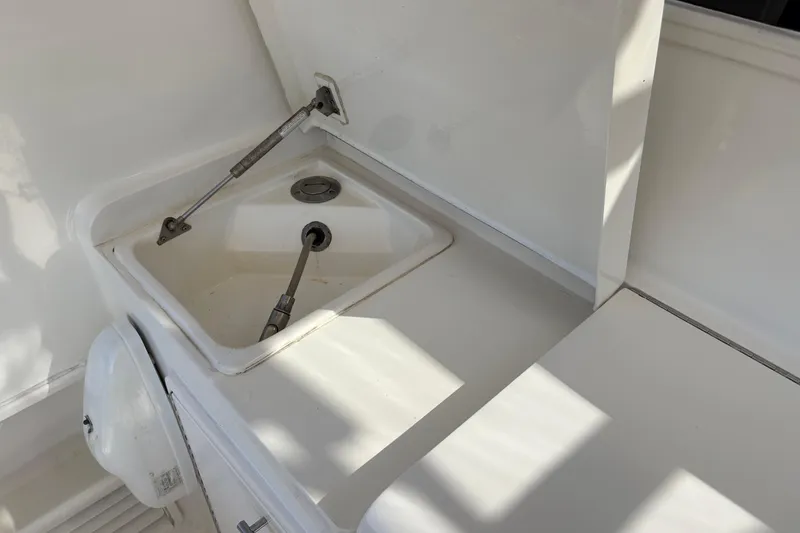 Slide: The Image of 1996 Ocean Yachts 48 Super Sport sink area with white countertop and fixtures. - 30