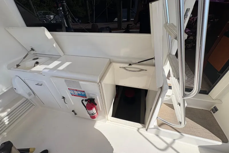 Slide: The Image of 1996 Ocean Yachts 48 Super Sport interior with sink, storage, and ladder. - 31