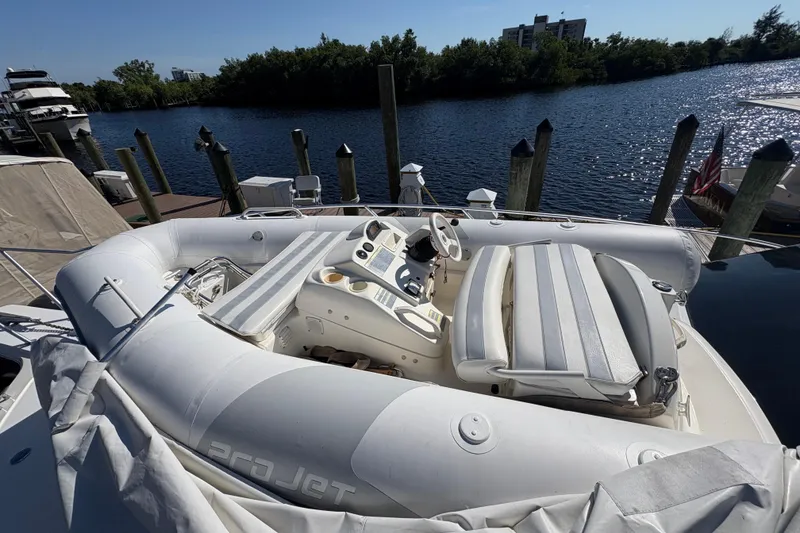 Slide: The Image of Inflatable boat on 1996 Ocean Yachts 48 Super Sport, docked by a serene waterfront. - 33