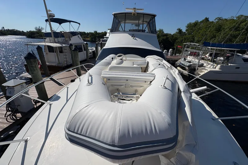 Slide: The Image of 1996 Ocean Yachts 48 Super Sport with inflatable boat on deck, docked at marina. - 34