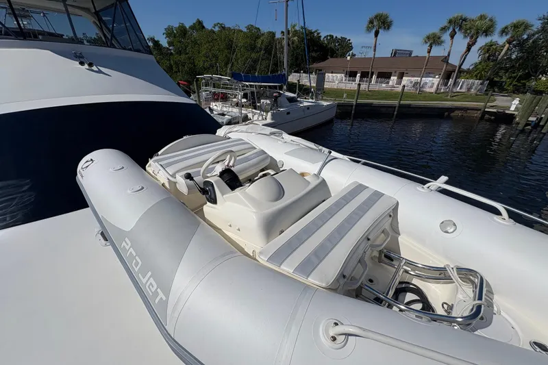 Slide: The Image of Inflatable boat on 1996 Ocean Yachts 48 Super Sport, docked near palm trees. - 35