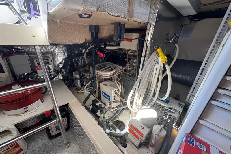 Slide: The Image of Engine room of 1996 Ocean Yachts 48 Super Sport with various equipment and wiring. - 40