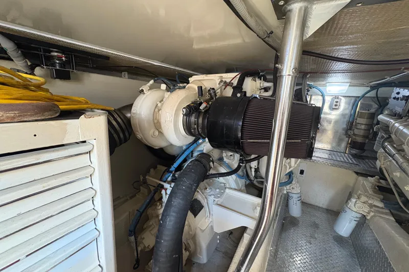 Slide: The Image of Engine room of a 1996 Ocean Yachts 48 Super Sport, showcasing mechanical components. - 42