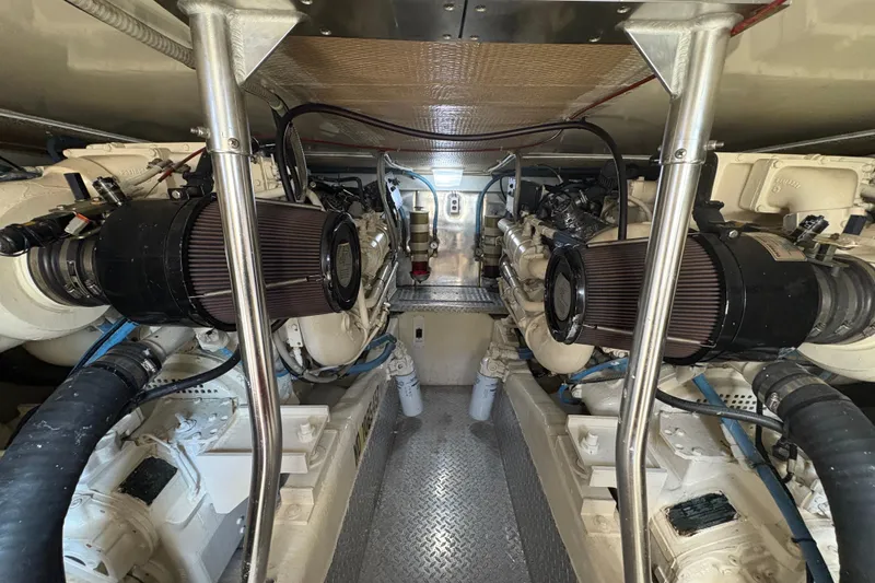Slide: The Image of Engine room of 1996 Ocean Yachts 48 Super Sport, showcasing dual engines and mechanical components. - 43