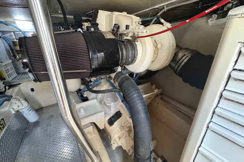 Slide: The Image of Engine room of 1996 Ocean Yachts 48 Super Sport, showcasing mechanical components and piping. - 44