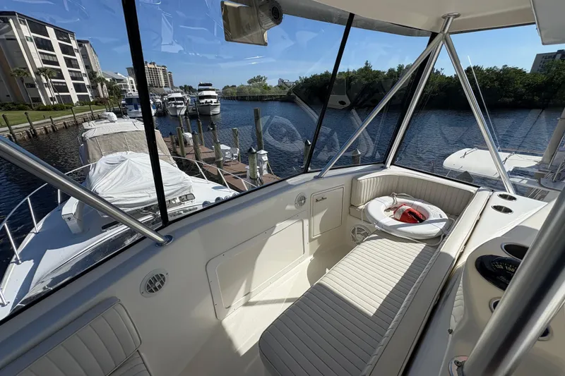 Slide: The Image of 1996 Ocean Yachts 48 Super Sport interior with marina view, featuring seating and life preserver. - 5