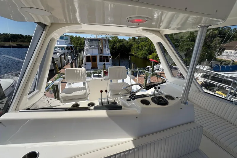 Slide: The Image of Interior view of 1996 Ocean Yachts 48 Super Sport, featuring helm and seating area. - 6