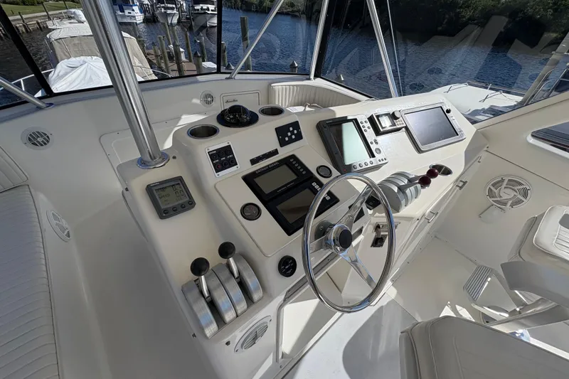 Slide: The Image of Cockpit of 1996 Ocean Yachts 48 Super Sport with navigation controls and steering wheel. - 8