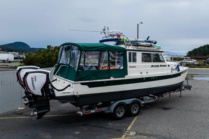 Slide: The Image of 2006 C-Dory 25' Tomcat Catamaran on trailer, equipped with Evinrude engines. - 1