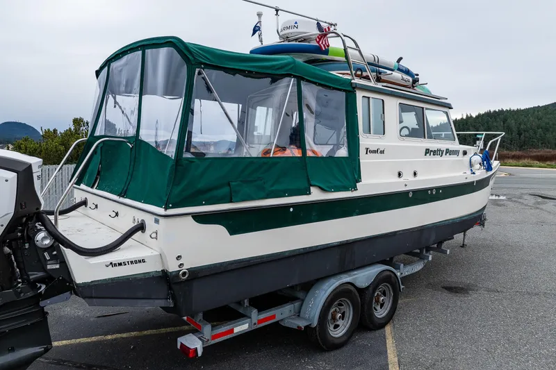 Slide: The Image of 2006 C-Dory 25' Tomcat Catamaran on trailer, green canopy, parked outdoors. - 10