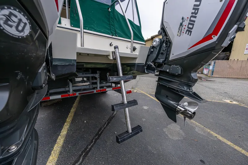 Slide: The Image of 2006 C-Dory 25' Tomcat Catamaran with outboard motors and ladder on trailer. - 14