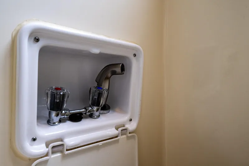 Slide: The Image of 2006 C-Dory 25' Tomcat Catamaran interior faucet with dual handles and spout. - 17