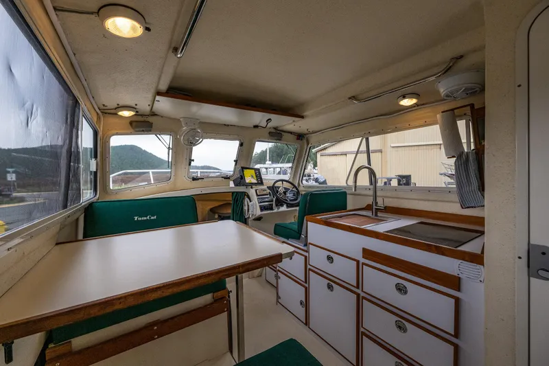 Slide: The Image of Interior of 2006 C-Dory 25' Tomcat Catamaran with dining area and kitchenette. - 22