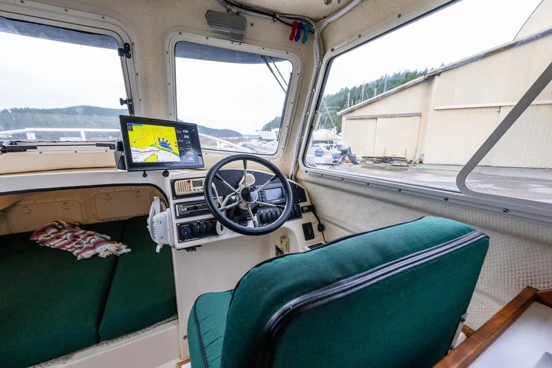 Slide: The Image of Interior of 2006 C-Dory 25' Tomcat Catamaran with steering wheel and navigation system. - 25