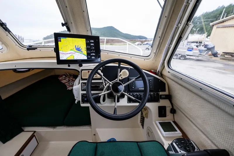 Slide: The Image of Interior view of 2006 C-Dory 25' Tomcat Catamaran cockpit with navigation equipment. - 26