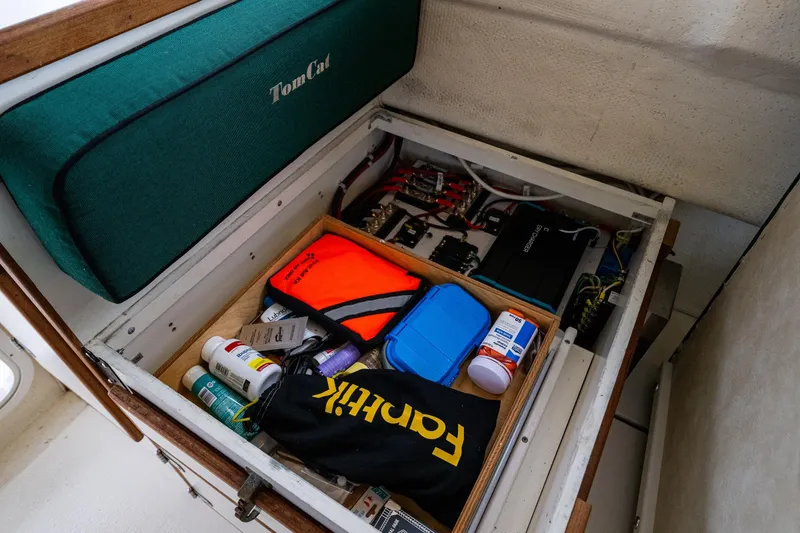 Slide: The Image of Storage compartment in a 2006 C-Dory 25' Tomcat Catamaran with various supplies and equipment. - 31