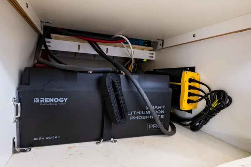 Slide: The Image of Renogy lithium battery setup in 2006 C-Dory 25' Tomcat Catamaran, featuring smart technology. - 33