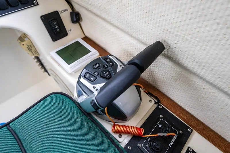 Slide: The Image of Control panel of a 2006 C-Dory 25' Tomcat Catamaran with throttle and switches. - 4