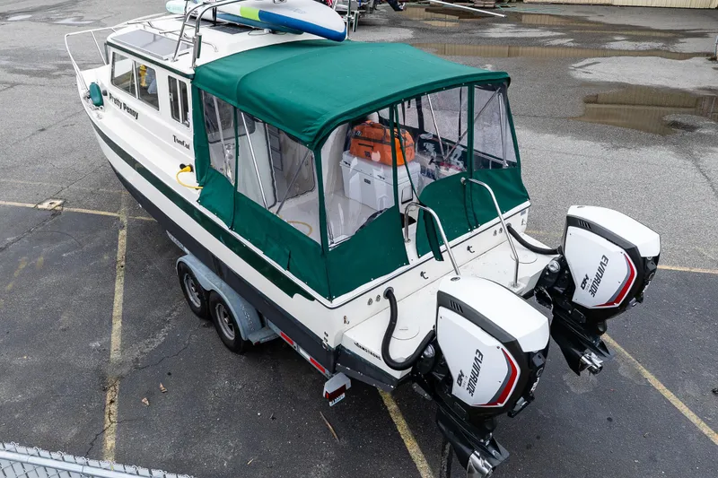 Slide: The Image of 2006 C-Dory 25' Tomcat Catamaran with green canopy and twin Evinrude engines. - 8