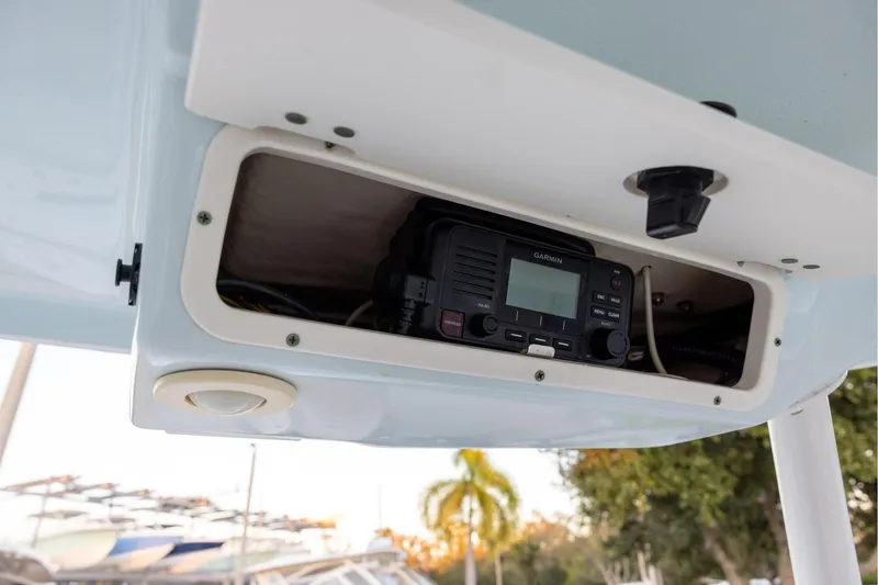 Slide: The Image of 2020 Robalo R247 Dual Console boat with Garmin radio in storage compartment. - 14