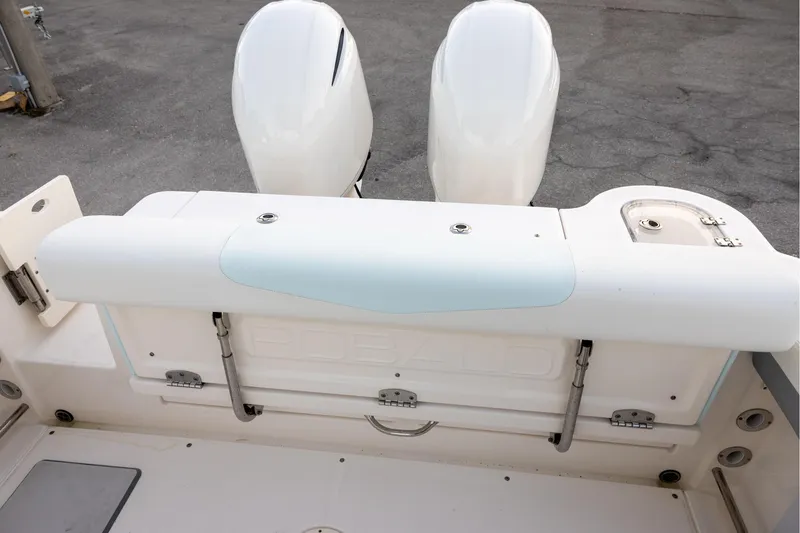 Slide: The Image of 2020 Robalo R247 Dual Console boat with twin engines and seating area. - 15