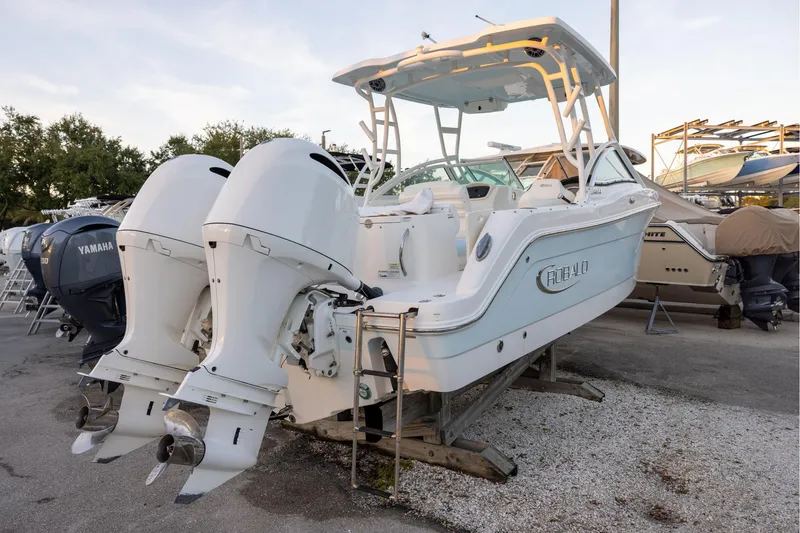 Slide: The Image of 2020 Robalo R247 Dual Console boat with twin outboard engines on display. - 2