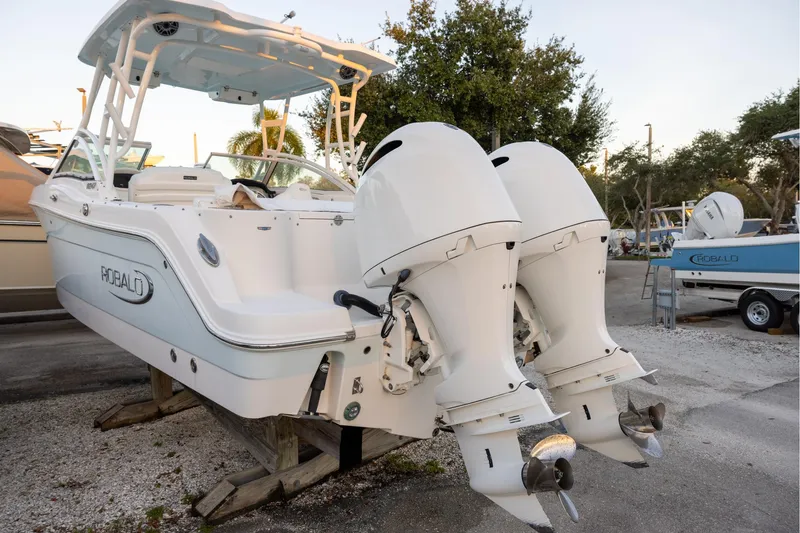 Slide: The Image of 2020 Robalo R247 Dual Console boat with twin outboard engines on display. - 3