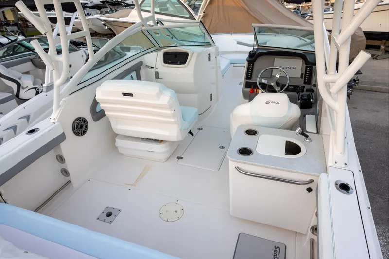 Slide: The Image of 2020 Robalo R247 Dual Console boat interior with helm, seating, and sink. - 4